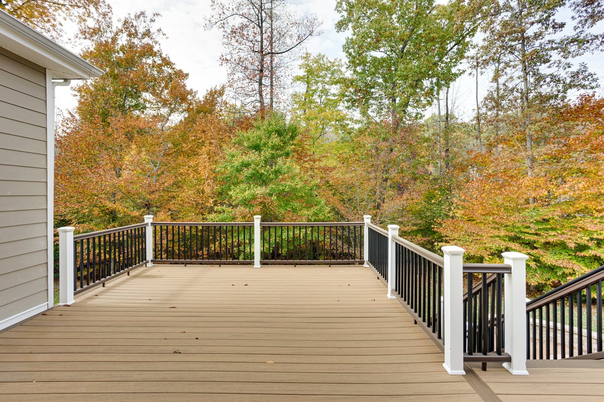 Wooden deck overlooking a forested yard and trees